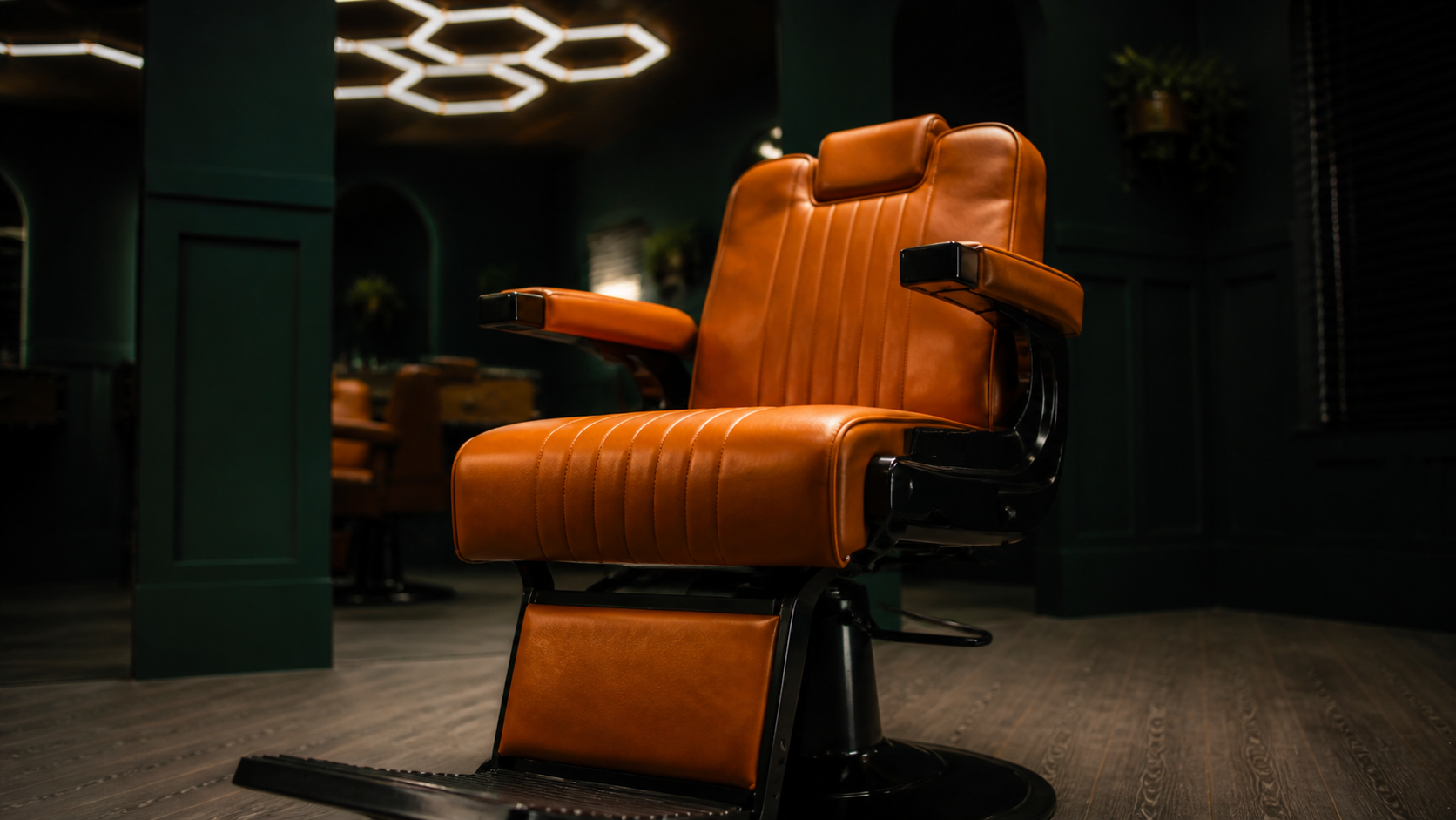 Orange leather barber chair in the JM Barber Co. studio in Lake Park, Florida