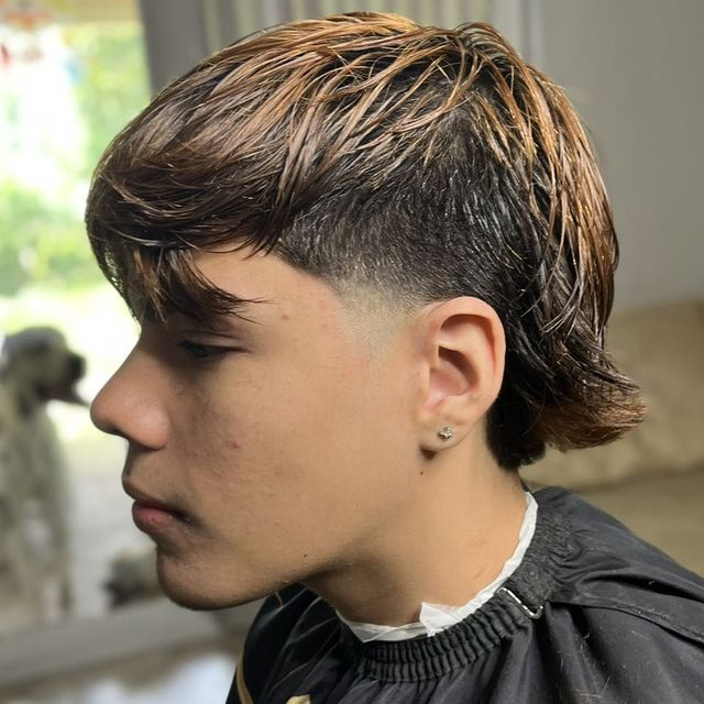 Textured flow haircut and mid taper at JM Barber Co. in Lake Park, Florida