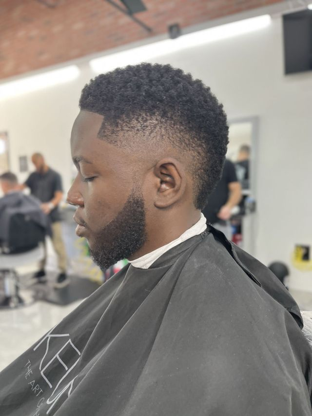 Curly taper fade and clean line up at JM Barber Co. in Lake Park, Florida